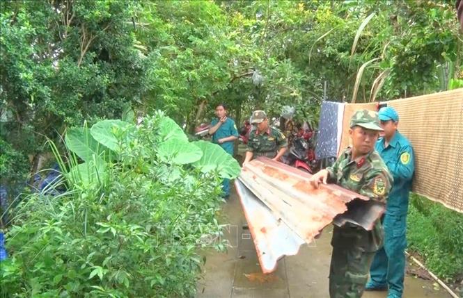 Lực lượng chức năng phường Bình Đức (tỉnh An Giang) hỗ trợ người dân dọn dẹp nhà cửa bị ảnh hưởng của bão số 3. Ảnh: Công Mạo-TTXVN