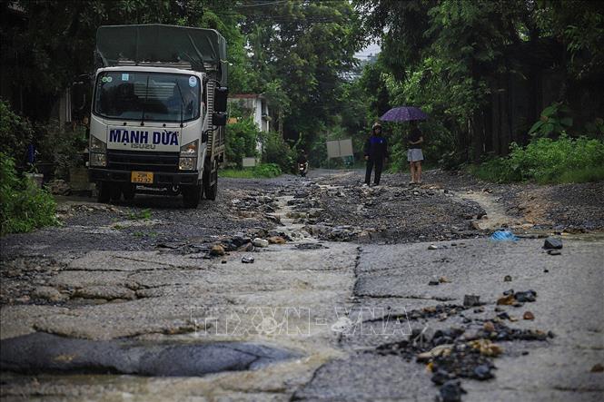 Nước lũ tràn ngầm thuộc một nhánh suối chảy ra sông Bùi và làm hư hại đường trên địa phận xã Lương Sơn. Ảnh: Trọng Đạt - TTXVN