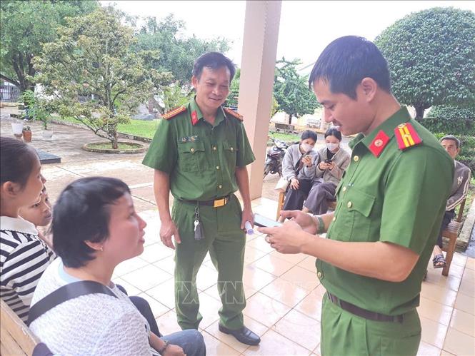 Cán bộ Công an xã Chư Păh, tỉnh Gia Lai, hướng dẫn người dân làm thủ tục hành chính trên điện thoại thông minh. Ảnh: Hoài Nam – TTXVN