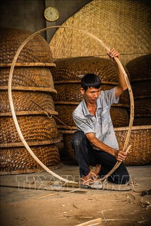 Các công đoạn để làm nên một chiếc thúng từ chọn tre, chẻ tre, vót tre đến đan mên, lận, nức… đều được người thợ làm thủ công, tỉ mỉ. Ảnh: Khánh Hòa – TTXVN 