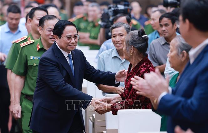 Thủ tướng Phạm Minh Chính với thân nhân liệt sĩ. Ảnh: Dương Giang-TTXVN

