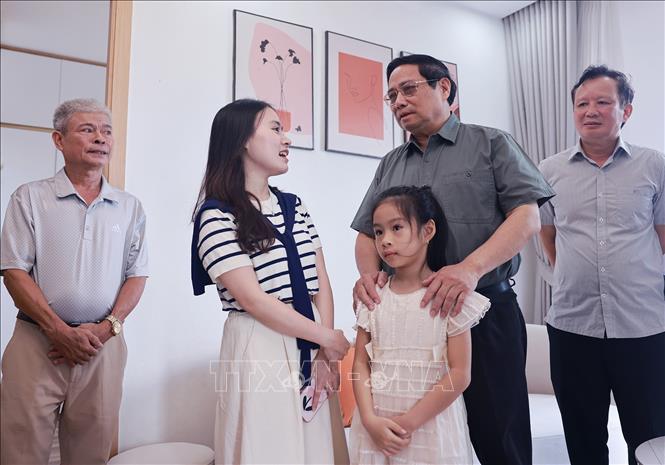 Thủ tướng Phạm Minh Chính thăm hộ gia đình đang thụ hưởng chính sách nhà ở xã hội tại thành phố Huế. Ảnh: Dương Giang-TTXVN 
