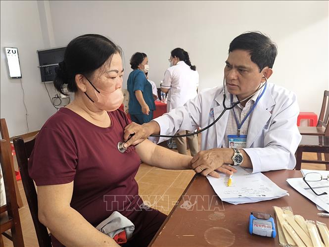 Bác sĩ khám bệnh cho người dân xã Đồng Khởi, tỉnh Vĩnh Long. Ảnh: Huỳnh Phúc Hậu - TTXVN