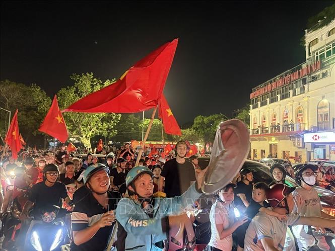 Người dân mang theo cờ Tổ quốc tập trung về khu vực Quảng trường Đông Kinh Nghĩa Thục để mừng chiến thắng. Ảnh: An Đăng - TTXVN