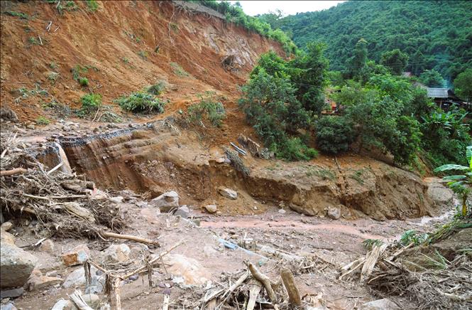 Không chỉ bị lũ cuốn trôi mất đường, điểm sạt lở núi với khối lượng hàng ngàn khối đất, đá, cây rừng đổ xuống, phủ kín suốt chiều dài gần 30m trên tuyến quốc lộ 16 đã gây chia cắt giao thông nghiêm trọng 10 ngày qua. Ảnh: Xuân Tiến - TTXVN 
