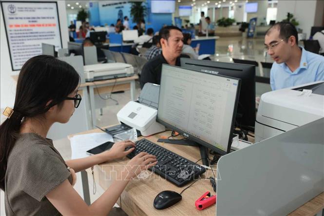 Công dân Lê Trang Anh (bên trái) đến làm thủ tục số hóa hành nghề luật sư tại Trung tâm. Ảnh: Hoàng Hiếu - TTXVN