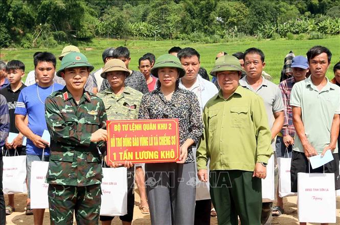 Đại diện Bộ Tư lệnh Quân khu 2 trao hỗ trợ 1 tấn lương khô cho đồng bào vùng lũ xã Chiềng Sơ. Ảnh: Quang Quyết - TTXVN