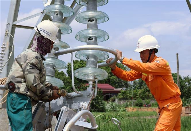Lắp đặt trụ sứ cách điện ở vị trí cột số 352, thuộc địa bàn xã Vũ Ninh, tỉnh Phú Thọ. Ảnh: Vũ Sinh - TTXVN