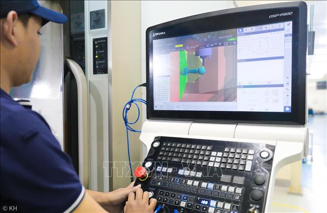 Công nhân đang vận hành gia công chi tiết máy. Ảnh: Thành Phương – TTXVN