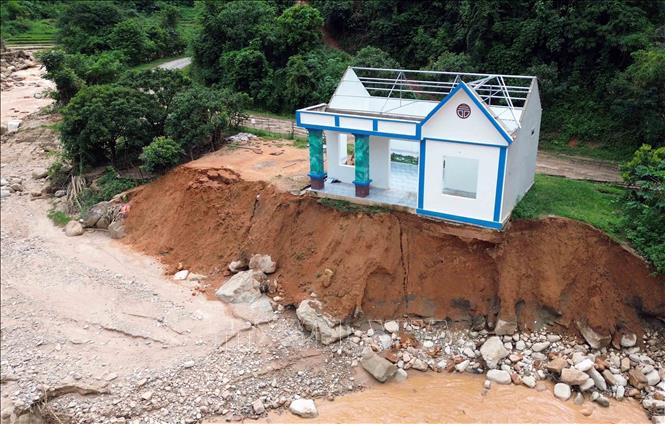 Mưa lớn gây lũ ống, lũ quét, sạt lở đất khiến một hộ gia đình phải di dời khẩn cấp, nguy cơ mất trắng nhà cửa. Ảnh: Quang Quyết - TTXVN