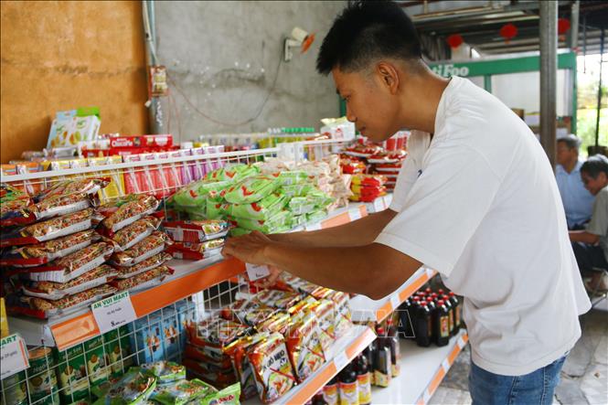Nạn nhân chất độc da cam Đặng Hữu Lộc ngụ phường Long Bình, tỉnh Đồng Nai sắp xếp, bày biện hàng hóa tại Cửa hàng tiện lợi An Vui Mart mới được hỗ trợ. Ảnh: Lê Xuân-TTXVN