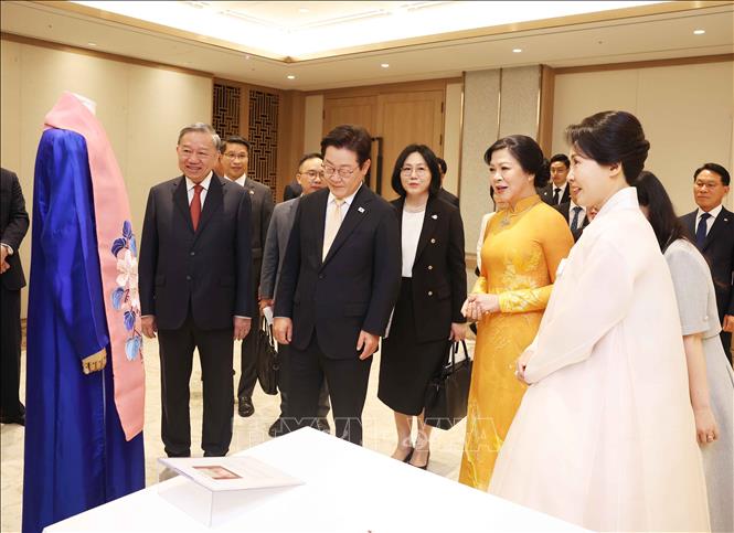 Tổng Bí thư Tô Lâm và Phu nhân giới thiệu tặng phẩm với Tổng thống Hàn Quốc Lee Jae Myung và Phu nhân. Ảnh: Thống Nhất - TTXVN