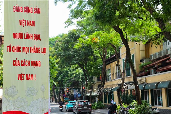 Những tuyến phố rợp bóng cây xanh của Hà Nội trở nên rực rỡ hơn với cờ hoa, pano, áp phích. Ảnh: Vũ Quang - TTXVN