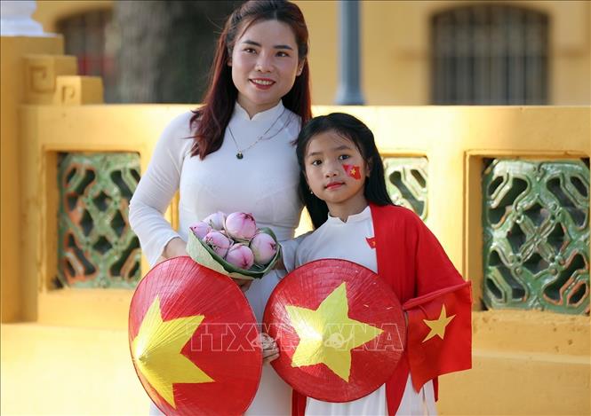 Hai mẹ con lưu lại những khoảng khắc ý nghĩa trong những ngày tháng Tám lịch sử. Ảnh: Khánh Hòa - TTXVN 