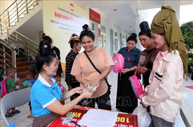 Trao tiền hỗ trợ của Tổng công ty Tư vấn thiết kế giao thông vận tải - CTCP cho các hộ dân xã Huổi Một. Ảnh: Quang Quyết - TTXVN