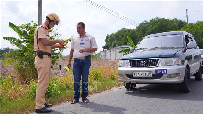 Cán bộ Phòng Cảnh sát giao thông, Công an tỉnh Tây Ninh kiểm tra việc chấp hành quy tắc giao thông của học viên và giáo viên dạy lái. Ảnh: Minh Phú – TTXVN