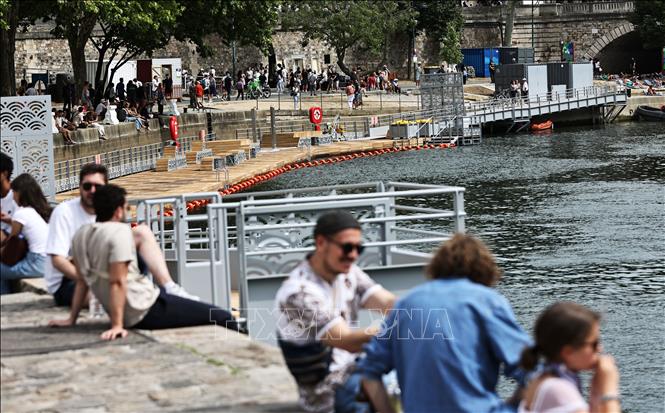 Người dân tránh nóng bên bờ sông Seine tại Paris, Pháp, ngày 5/7/2025. Ảnh: THX/TTXVN