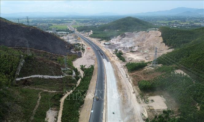 Nhà thầu tăng tốc thi công 3 ca, 4 kíp thảm nhựa những đoạn cuối cùng trên tuyến. Ảnh: Quốc Khánh - TTXVN