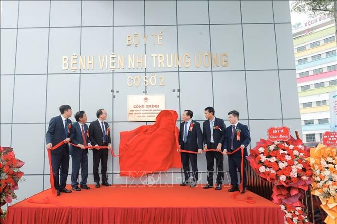 Đại biểu thực hiện nghi thức gắn biển công trình. Ảnh: Minh Quyết - TTXVN
