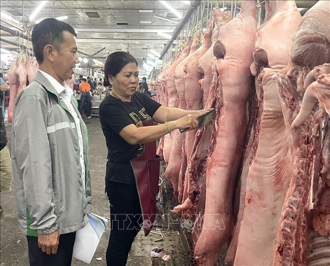 Ban quản lý chợ đầu mối nông sản thực phẩm Hóc Môn tuyên truyền, vận động thương nhân đảm bảo an toàn thực phẩm kinh doanh tại chợ. Ảnh: Hương Giang – TTXVN