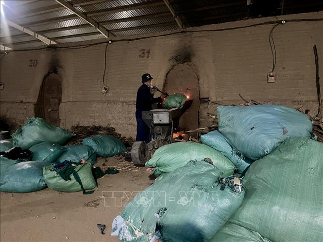 Công nhân vẫn ngang nhiên đốt vải. Ảnh: Sỹ Thắng/TTXVN