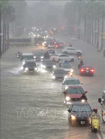 Mưa lớn ảnh hưởng đến việc di chuyển của người dân đầu giờ sáng tại KĐT Times City. Ảnh: Thanh Tùng - TTXVN