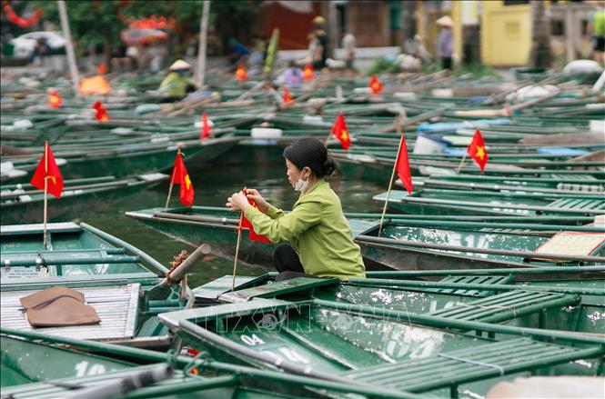 Lái đò Khu du lịch Tam Cốc - Bích Động, phường Nam Hoa Lư, tỉnh Ninh Bình trang trí cờ Tổ quốc chuẩn bị đón khách dịp lễ 2/9. Ảnh: Thùy Dung - TTXVN