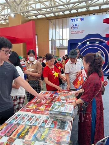 Khách tham quan tìm hiểu, trải nghiệm tại gian hàng của TTXVN. Ảnh: TTXVN 