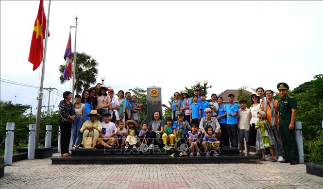 Trước khi trải nghiệm mùa nước nổi trên đồng ruộng, du khách đến tham quan, chụp ảnh lưu niệm với cột mốc biên giới Quốc gia tại Cửa khẩu quốc tế Thường Phước (xã Thường Phước). Ảnh: Nhựt An - TTXVN