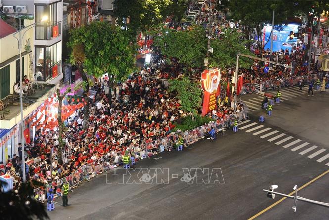 People gather on Hanoi's streets to wait the parade. VNA Photo