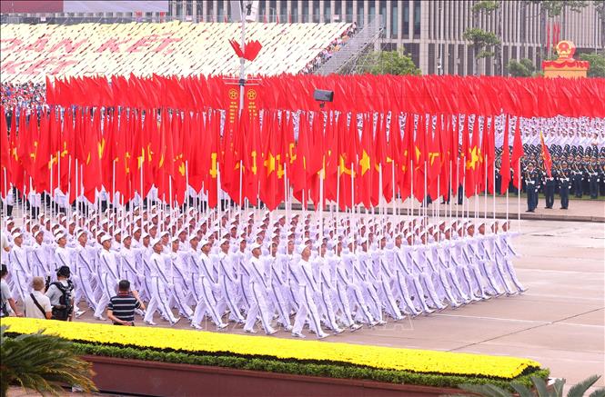 A formation carries Party flags and national flags. VNA Photo
