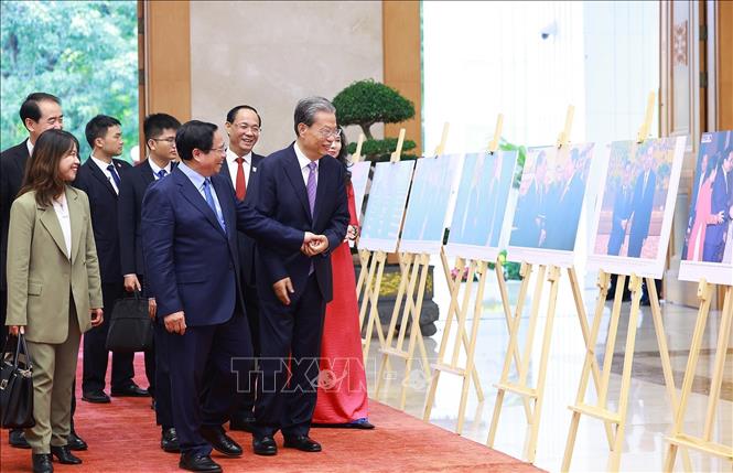 Thủ tướng Phạm Minh Chính và Ủy viên trưởng Nhân đại toàn quốc Trung Quốc Triệu Lạc Tế tham quan trưng bày Ảnh về quan hệ hợp tác giữa hai nước do TTXVN thực hiện. Ảnh: Dương Giang-TTXVN
