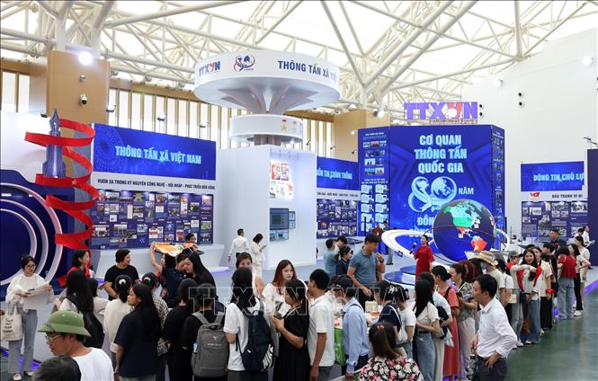 Đổng đảo nhân dân xếp hàng nhận ấn phẩm của Thông tấn xã Việt Nam được trưng bày trong triển lãm. Ảnh: Quốc Khánh - TTXVN