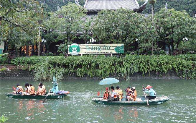 Tourists take boat trips to Trang An Eco-tourist Site in Ninh Binh province. VNA Photo 