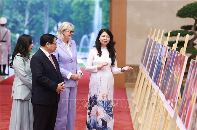 Thủ tướng Phạm Minh Chính và Toàn quyền Australia Sam Mostyn tham quan trưng bày ảnh về quan hệ hợp tác giữa hai nước, do Thông tấn xã Việt Nam thực hiện. Ảnh: Dương Giang – TTXVN
