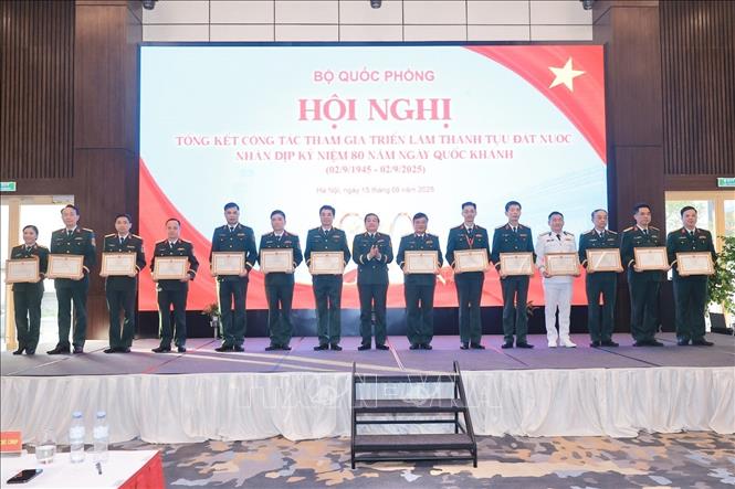 Thượng tướng Trương Thiên Tô, Phó Chủ nhiệm Tổng cục Chính trị Quân đội Nhân dân Việt Nam tặng Bằng khen của Bộ trưởng Bộ Quốc phòng cho tập thể, cá nhân có thành tích xuất sắc trong công tác triển lãm. Ảnh: Minh Quyết - TTXVN