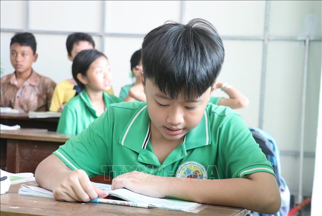 Thạch Hoàng Gia Bảo, 12 tuổi vẫn đang theo học chương trình lớp 2 ở lớp học tình thương của Đồn Biên phòng Cửa khẩu Cảng Bến Lức, với hy vọng tương lai có thể làm thầy giáo để dạy các em có hoàn cảnh khó khăn như mình. Ảnh: Bùi Giang - TTXVN