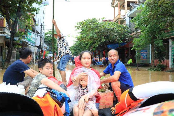 Người dân được lực lượng chức năng tỉnh Lào Cai hỗ trợ di chuyển đến nơi an toàn. Ảnh: Tuấn Anh - TTXVN