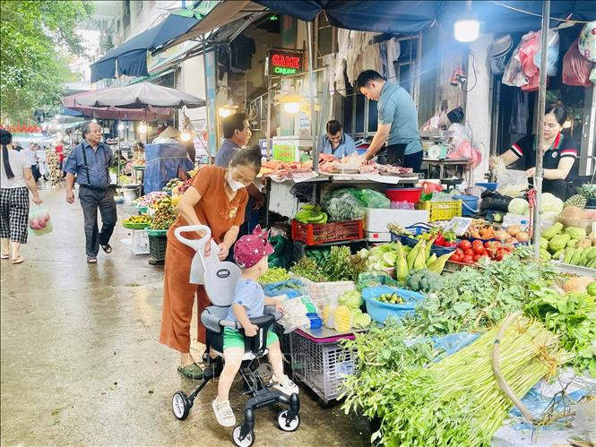 Khu chợ dân sinh ở Linh Đàm nhộn nhịp trở lại nhưng mặt hàng rau xanh tăng giá. Ảnh: Tuyết Mai - TTXVN