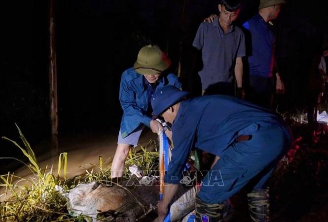 Cán bộ, chiến sĩ Trung đoàn 2, Sư đoàn 3 đóng quân trên địa bàn và nhân dân tổ chức ứng cứu, khắc phục sự cố ngay trong đêm. Ảnh: TTXVN-phát