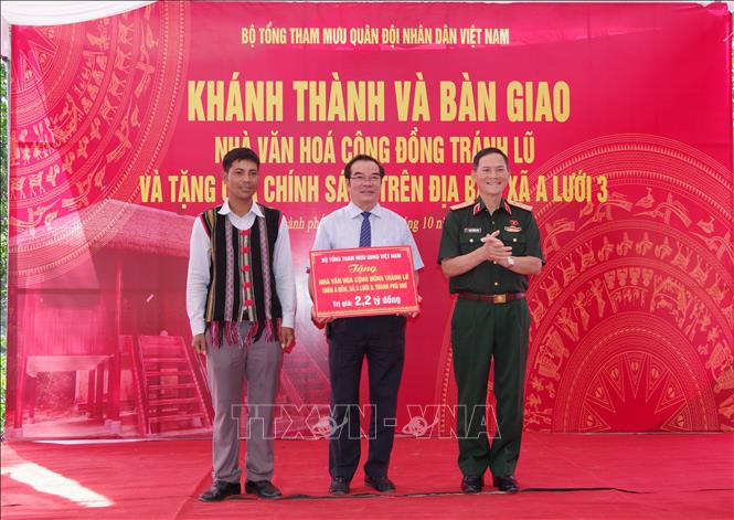 Bàn giao Nhà văn hóa cộng đồng tránh lũ tại thôn A Đên cho lãnh đạo UBND xã A Lưới 3. Ảnh: TTXVN phát