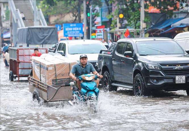 Đến trưa 8/10, đường phía trước Bệnh viện K Tân Triều vẫn còn ngập. Ảnh: Hoàng Hiếu - TTXVN