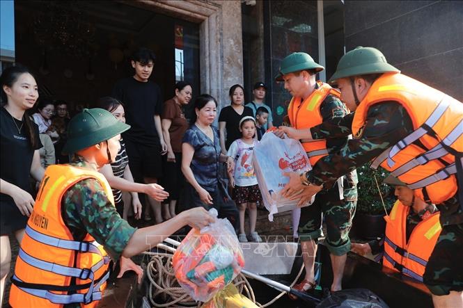 Đoàn cứu hộ Quân khu 1 vận chuyển đồ ăn, nước uống cho người dân khu vực bị ngập sâu ở phường Phan Đình Phùng, tỉnh Thái Nguyên. Ảnh: Minh Quyết - TTXVN