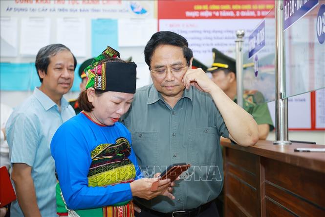 Thủ tướng Phạm Minh Chính thăm hỏi nhân dân đến làm thủ tục tại Trung tâm Phục vụ hành chính công xã Bát Mọt, tỉnh Thanh Hoá. Ảnh: Dương Giang-TTXVN
