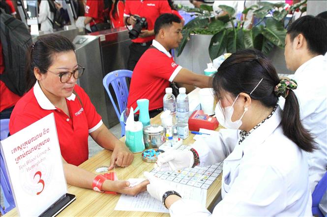 Các tình nguyện viên, nhân viên Công ty Metfone cung cấp mẫu máu tại chương trình. Ảnh: Hoàng Minh- PV TTXVN tại Campuchia 