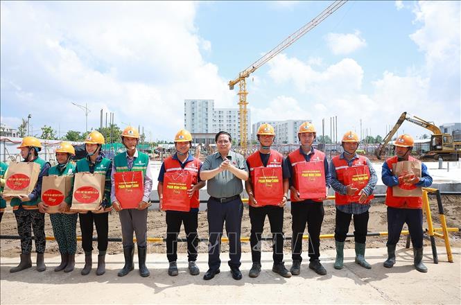 Thủ tướng Phạm Minh Chính tặng quà công nhân thi công dự án Khu nhà ở xã hội của thành phố Cần Thơ. Ảnh: Dương Giang-TTXVN 

