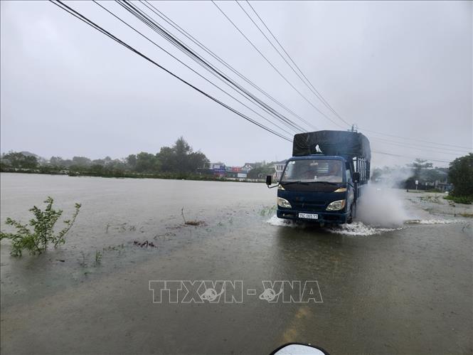 Xe cộ đi lại khó khăn qua vùng nước ngập sâu. Ảnh: Mai Trang- TTXVN 