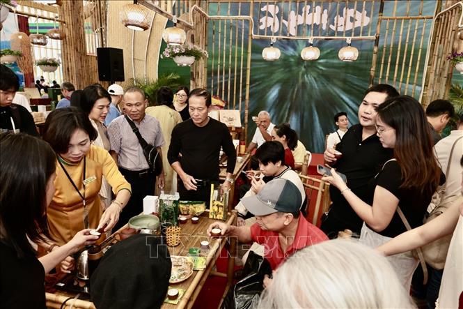 Du khách thưởng thức chè đến từ gian hàng Thái Nguyên. Ảnh: Trần Việt - TTXVN