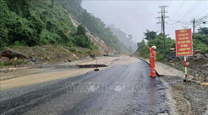 Nhân viên điện lực kiểm tra đường dây điện tại các khu vực bị sạt lở do mưa lũ. Ảnh: TTXVN phát 
