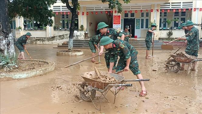 Công tác dọn dẹp bùn đất sau lũ tại Đà Nẵng đang được các chiến sỹ Quân khu 5 khẩn trương triển khai. Ảnh: Khoa Chương - TTXVN